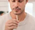 Man wearing a breathing necklace with a white shirt